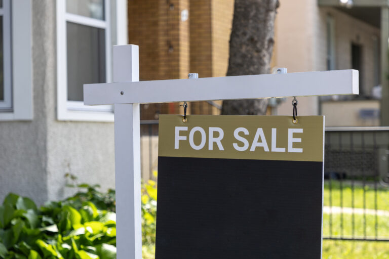 A "For Sale" sign is displayed in front of a residential house, signaling that selling your home in St. Cloud could be your next step if you're looking to put your property on the market.