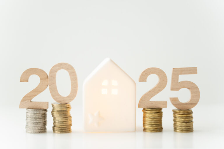 Wooden numbers "2025" placed on stacks of coins with a small white house figurine in the center, symbolizing the Florida real estate market 2025, set against a plain white background.
